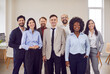 © Studio Romantic - Portrait of a happy and diverse group of business people in an office. The multinational team of coworkers is engaged in teamwork, reflecting a positive and collaborative work environment.
