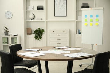 Canvas Print - Wooden table, chairs and white board with sticky notes in conference room