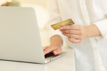 Canvas Print - Online banking. Woman with credit card and laptop paying purchase at white table, closeup