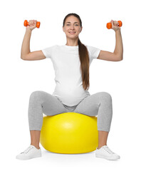 Canvas Print - Beautiful pregnant woman with dumbbells doing exercises on fitball against white background