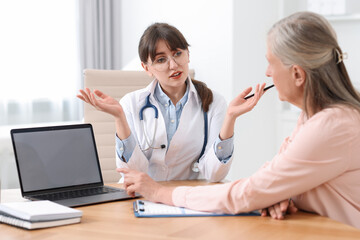 Sticker - Lung disease. Doctor consulting patient at table in clinic