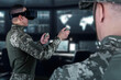 © TSViPhoto - Warfare pilot using head-mounted displays VR glasses, digital device operating with robot, drone or troops of mechanical soldiers. The military's training virtual simulators, AI technology
