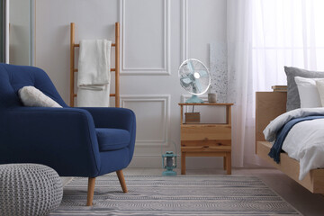 Sticker - Stylish living room interior with bed, bedside table and fan