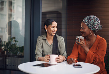 Canvas Print - Talking, happy and women with coffee at cafe for conversation, chatting or lunch break. Relax, discussion and female friends with cup for caffeine, cappuccino and beverage at outdoor restaurant