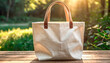 © 9KHOU - Blank white canvas tote bag mockup on a sunlit table, perfect for showcasing designs This eco-friendly product  is perfect for promoting sustainable living simple, and durable design.