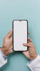 Poster - Hands of a medical professional holding smartphone with blank screen on light blue background. Doctor showing phone mockup for healthcare application.