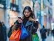 © Sumet - Stylish Asian woman carrying colorful bags, using her mobile phone, in a bustling city street
