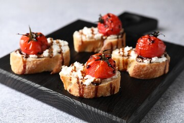 Canvas Print - Bruschettas with ricotta cheese, tomatoes and balsamic sauce on grey table, closeup