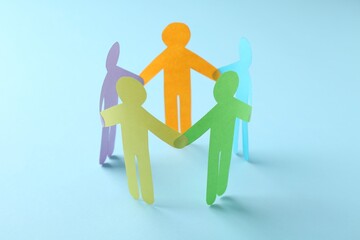 Wall Mural - Equality concept. Paper human figures on light blue background, closeup