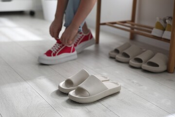 Canvas Print - Woman changing into slippers at home, closeup