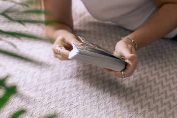 Hands of a young girl and tarot cards