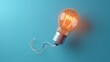 © Pornphan - Creative Concept of a Light Bulb on a Blue Background Representing Innovation and Bright Ideas