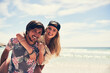 © JordaanExams/peopleimages.com - Couple, beach and piggyback on holiday for travel in Puerto Rico, happiness for freedom in nature. Wellness, adventure or man with support for woman by ocean, together on island vacation in portrait