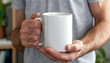 © Oleksiy - Man holding white mug indoors, closeup. Mockup for design