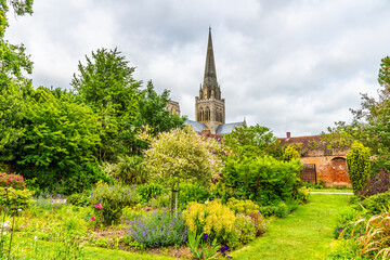 Wall Mural - A view past flower beds towards the Chichester Cathedral in the center of Chichester, Sussex in summertime