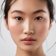 © LofiAnimations - Beautiful Asian Woman, Close up on her face with Smooth skin look at the camera on a White background in Studio light. generative AI. Asian pretty girl. Photo realistic.