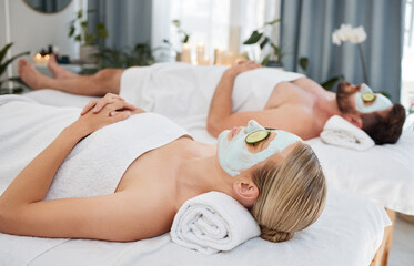 Canvas Print - Spa, relax and couple with cucumber facial for health, wellness and bonding with luxury hotel service. Skincare, man and woman on bed with mask, vitamin c and cosmetics for self care therapy at salon