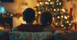 © ClicksdeMexico - A boy and girl are sitting on a couch in front of a Christmas tree