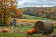 © MK studio - Autumn landscape with pumpkin field, red barn, and colorful foliage. Misty mountains in background under blue sky with fluffy clouds. Scenic rural farmland in fall season.