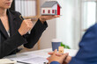 © Kritdanai - A real estate agent talks with his client regarding a home purchase contract, concept for real estate, moving house or renting property.