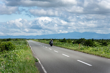 road in the countryside with motorcyclist