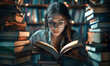 © Cantarela - Young woman wearing glasses reading a book surrounded by stacks of books in a library at night.Education and learning concept.Knowledge Day, World Book Day