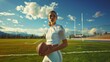 © Scott  - A woman in a white sports outfit holding a football, standing on the green field with goalposts behind.