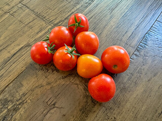 Red, ripe cherry tomatoes on a wooden table