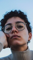 Poster - A close up portrait of a young person wearing glasses, looking away from the camera