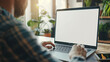 © iamfrk7 - Over shoulder shot of a young man using computer laptop in front of an blank white computer screen in home