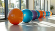 © Matthias - Artistic shot of exercise balls lined up in bright airy fitness studio