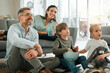 © KayJoint/peopleimages.com - Parents, kids and smile for watching tv in home with popcorns for movies, film and series. Family, people and happy for bonding with streaming platform or subscription for entertainment in lounge