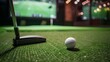 © Gia - This image displays a golf ball resting near a putter on an artificial green surface in an indoor setting, with the detailed elements and virtual golf environment in the background.