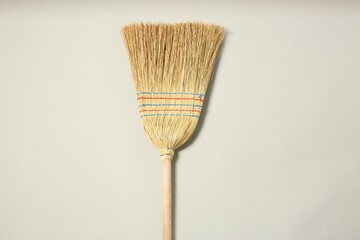 Wall Mural - One corn straw broom on grey background, top view