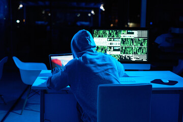 Fototapete - Dark, person or hacker with laptop for cybercrime, malware or phishing for stealing online data. Programmer, night or typing software update on computer with hacking expert writing algorithm system