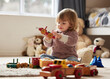 © CineLens2024/peopleimages.com - Baby, toys and play in home for development or learning, child in bedroom for motor skills. Young kid, house and relax game with wood cars for education or creativity, wellness or cognitive growth