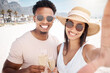 © peopleimages.com - Couple, selfie and happy at beach with champagne glasses for holiday and honeymoon in Bali. People, relationship and smile with toast for anniversary celebration on vacation, break and bonding