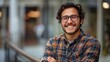 © ifoto - Young smiling happy man wearing glasses standing with arms crossed looking at camera