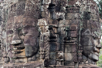 Wall Mural - Closeup of huge head sculpture at the historic temple complex of Angkor Wat in Siem Reap, Cambodia