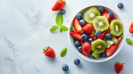 Wall Mural - A bowl of mixed fruit with strawberries, blueberries, and kiwi slices.