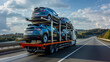 © ihalilyp - Tow truck car carrier semi trailer on highway carrying batch of new wrapped electric SUVs on motorway