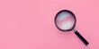 © Kaplitskaya Love - A magnifying glass is on a pink background