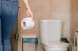 © Ivan - woman takes toilet paper in the bathroom