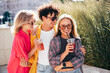 © halayalex - Young three stylish friends posing in the street. Fashion man and two cute female dressed in casual summer clothes. Smiling models having fun. Cheerful women and guy outdoors, Hold and drink lemonade