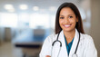 © Adrianna - Beautiful smiling physician in medical uniform with blurred hospital background.