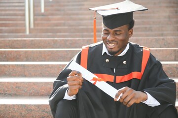 smiling african american graduated student showing diploma