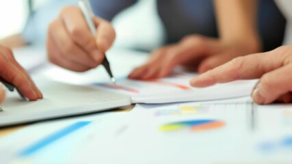 Aufkleber - Team collaborating on financial documents with charts and graphs in an office. Close-up of hands pointing and writing. Ideal for business strategy and teamwork concepts 