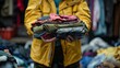 © ArtBox - Volunteer holds donated clothing