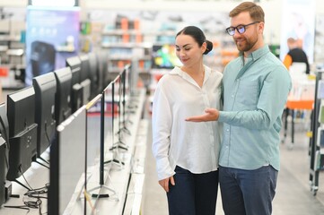 Wall Mural - Couple buying television at store