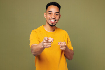 Wall Mural - Young man of African American ethnicity he wear yellow t-shirt casual clothes point index finger camera on you motivating encourage isolated on plain pastel green background studio. Lifestyle concept